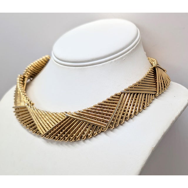 Circa 1970s or 1980s goldtone metal wires overlapping each other forming v patterns collar necklace with fold over clasp....