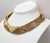Circa 1970s or 1980s goldtone metal wires overlapping each other forming v patterns collar necklace with fold over clasp....