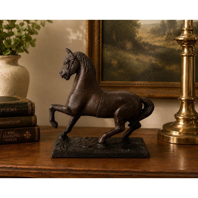 This antique cast metal horse statue dates to the early 20th century and was originally designed as a decorative clock...