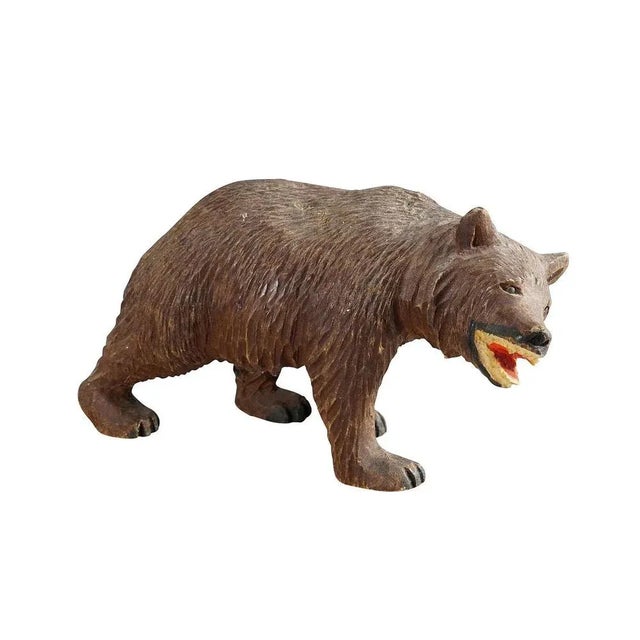 A vintage statue of a walking bear. Made of lindenwood, finely handcarved with naturalistic details in Brienz, Switzerland...