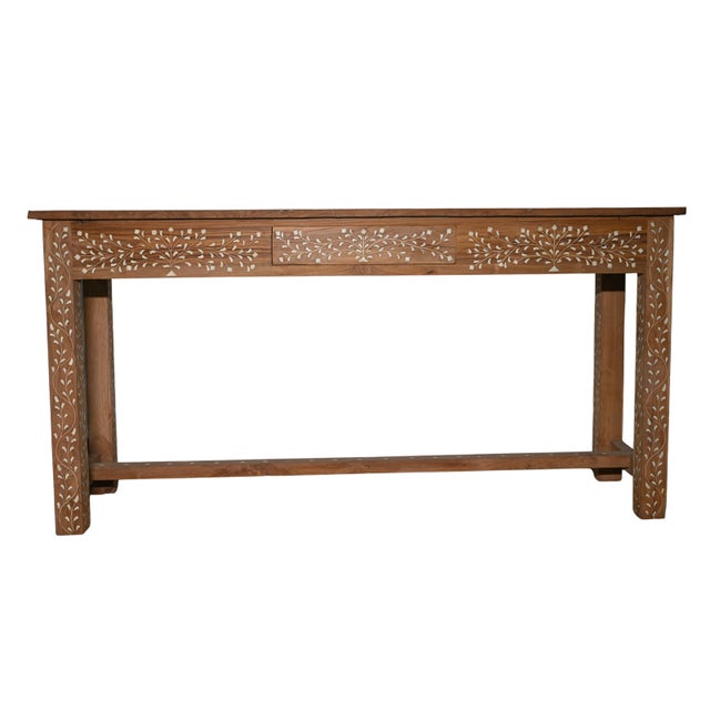 This handcrafted console table is made from solid wood and finished in a warm, medium-brown tone that highlights the...