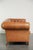 This unique 2.5-seater Chesterfield sofa, made of sheepskin and in excellent condition, features a beautiful light cognac...