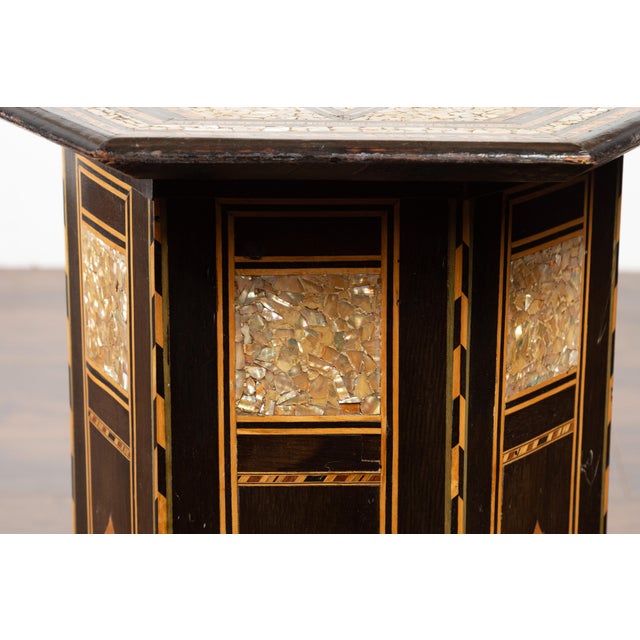 A Moroccan side table from the mid 20th century, with inlaid star motif. Created in Morocco during the midcentury period,...
