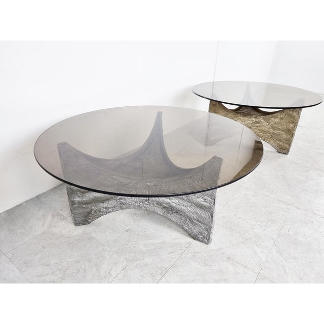 Spectacular coffee tables with a cast aluminum base and a smoked glass top. Beautiful statement piece that mixes well with...