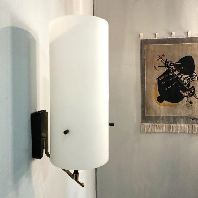 Pair of Stilnovo wall lights, designed and manufactured in Italy during the 1960's by Stilnovo. Each sconce features a...