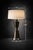 Mobile-Ready Blurb A striking architectural table lamp defined by bold brutalist geometry and a rich aged bronze finish....