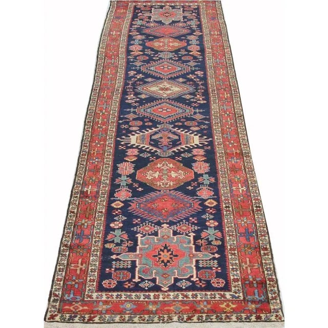 ACTUAL SIZE: 3’5″ x 13’4″ PRIMARY COLOR: Rust / Navy AGE: Old MATERIALS: Wool FOUNDATION: Cotton PRODUCTION: Handwoven,...