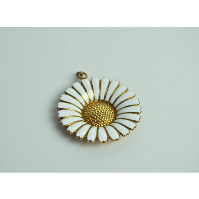 Marguerite pendant in gold-plated sterling silver with white enamel. Produced by Goldsmith Bernhard Hertz, Copenhagen and...