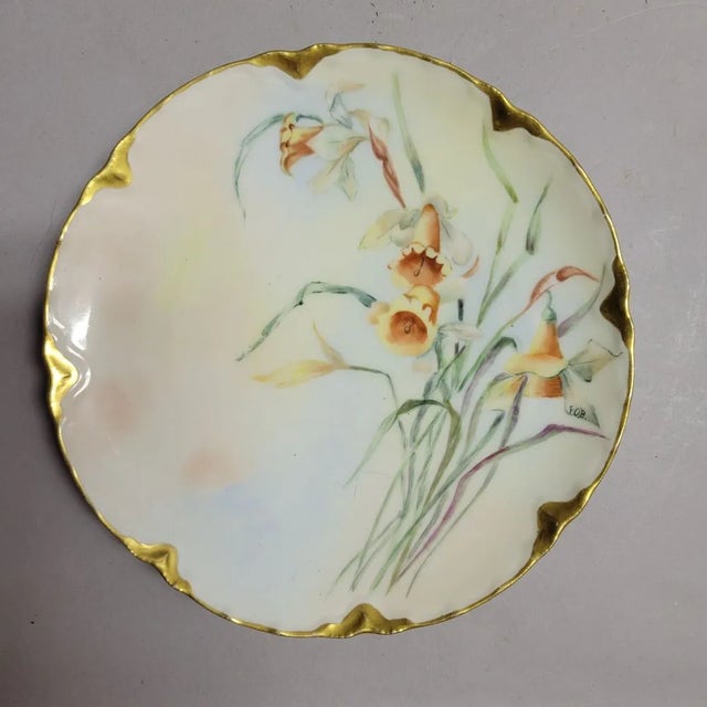 A pair of lovely hand painted Haviland Limoges plates dated 1905 and signed with the initials EOB. Gold trim.