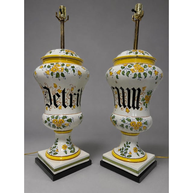 A decorative pair of Italian maiolica apothecary jars, likely dating to the 20th century, now converted to table lamps...