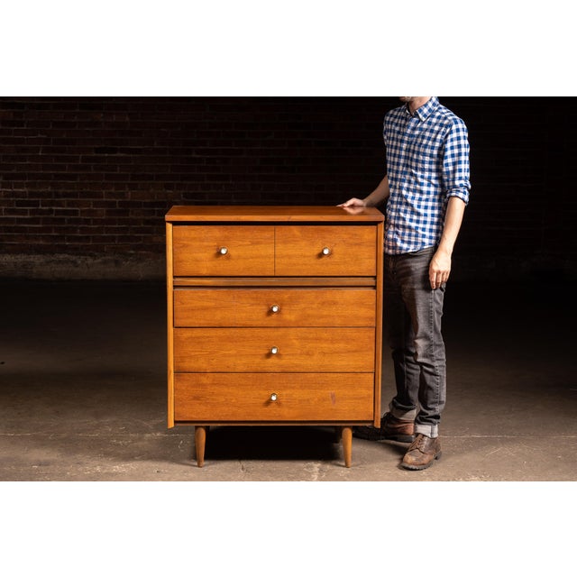 Mid-century modern tall dresser produced under the Harmony House brand for Sears, Roebuck and Co. The warm walnut-toned...