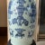 This striking late 19th-century Chinese blue and white porcelain baluster vase features a classic trumpet neck and vibrant...