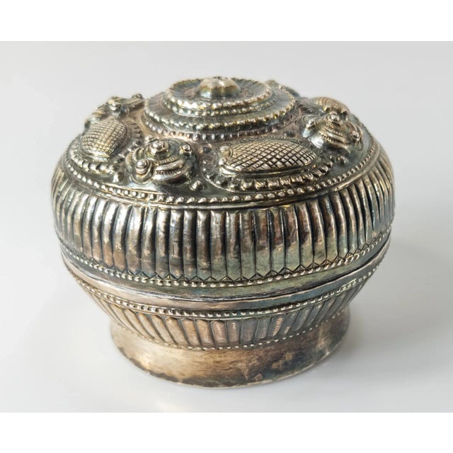 We are selling this nice little betel box. This South East Asian box has repousse decoration on the lid with...