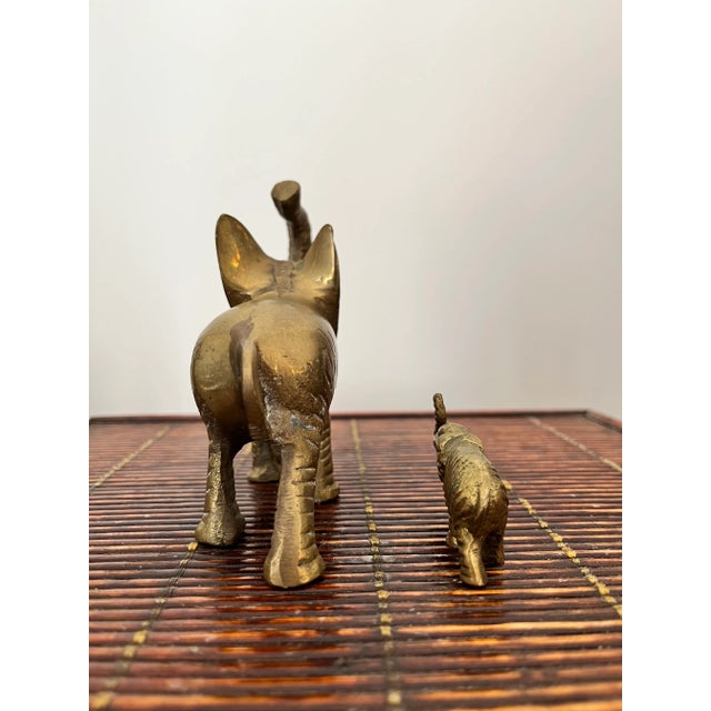 Adorable vintage trunks up baby and parent brass elephants from the Mid-Century. In Feng Shui, elephants symbolize...