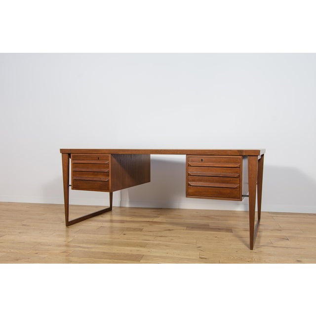 Model 70 desk designed by Kai Kristiansen for the Danish manufacture Feldballes Møbelfabrik in the mid-1960s. A modernist...