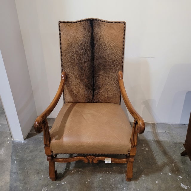 Elevate your space with this stunning pair of handcrafted animal hide side chairs, where luxury meets versatility....