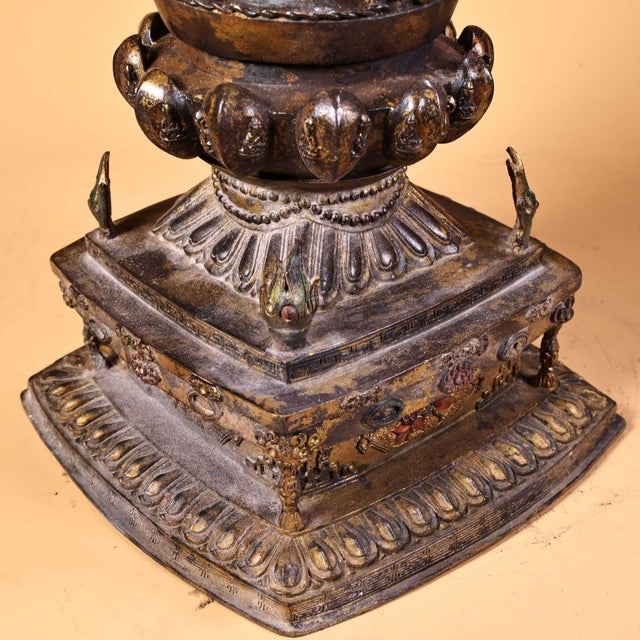 A substantial vintage Tibetan Buddhist stupa (chorten), hand cast in solid bronze with partial gilded finish and elaborate...