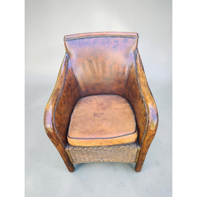 A unique vintage club chair with a striking, sculptural form, combining natural materials and artisanal craftsmanship. The...
