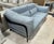 Ligne Rose City Loft Loveseat. Features a slip-cover style seat cushions upholstered in a textured-stitched blue fabric,...