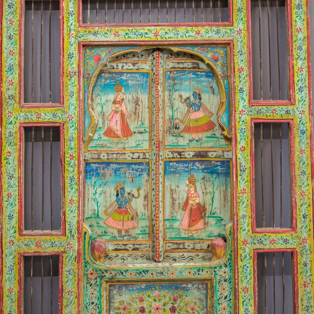 This antique newly painted window surround from India is a unique handcrafted item featuring intricate painted details and...