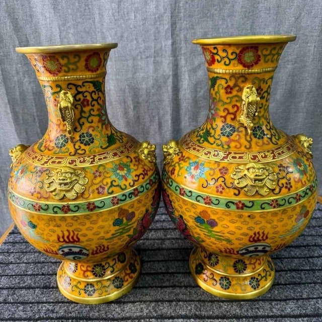 Make a grand statement with this spectacular pair of monumental cloisonné enamel vases. A true tour de force of...