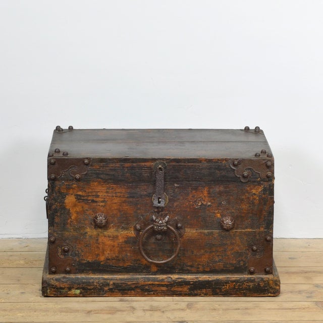 A highly decorative antique Japanese wooden storage chest, dating from the Meiji period (circa 1870–1910). The chest is...