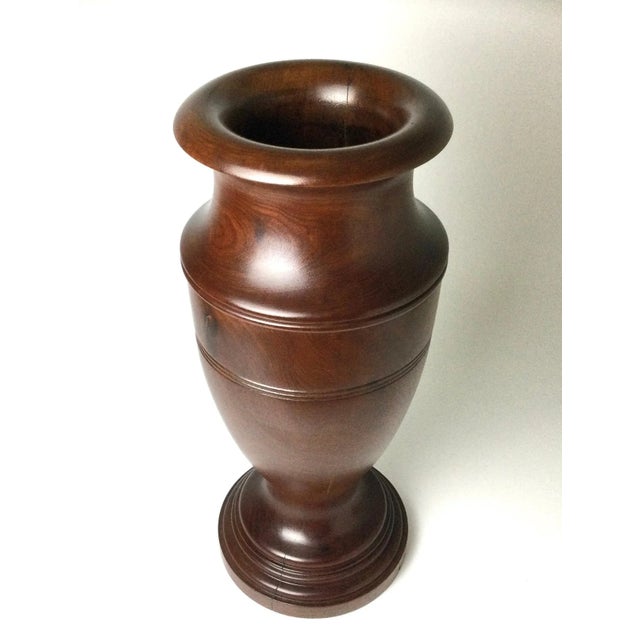 This example is made from one solid piece of mahogany. Hand turned. It has been re-finished and has some natural checking...
