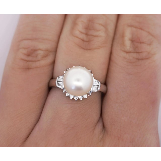 9.5mm South Sea Cultured Pearl and Diamond Ring in Platinum. The white pearl is surrounded by round cut shining diamonds...