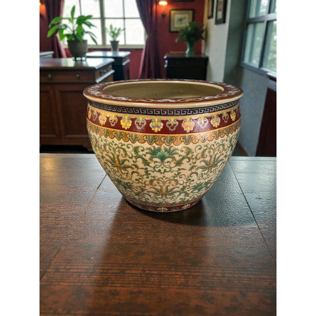 The Vintage Koi-Fish Asian Chinoiserie Fishbowl Jardinière Planter is a large, round ceramic planter with a unique Asian...
