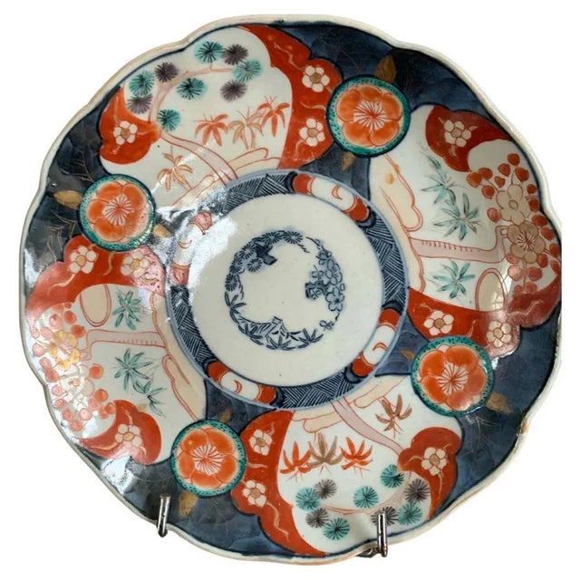 Beautiful porcelain plate with imari decoration. On this plate, the background is blue and white, with reserves in which...