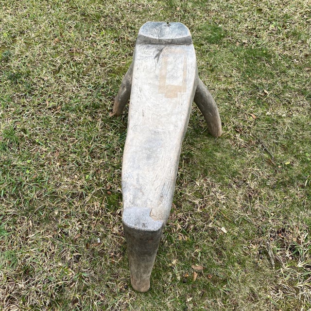 Hand crafted antique wooden bench from Java, Indonesia. Late 19th century Very unusual three legged design. Top board and...
