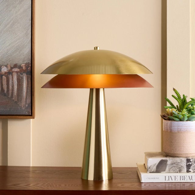 Illuminate your space with the Rafaela table lamp, standing at 21.5 inches of captivating design. This brass lamp combines...