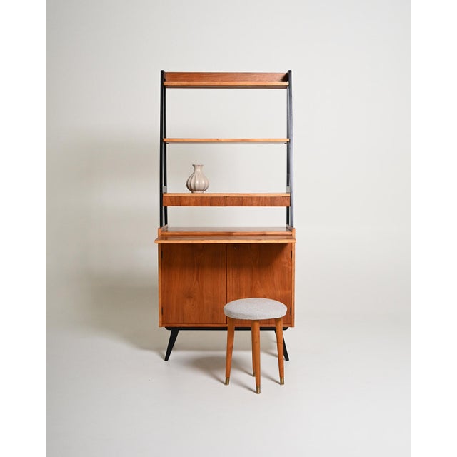 Teak frame with black lacquered uprights, open shelves, two drawers, a pull-out shelf, and a storage compartment with...