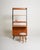 Teak frame with black lacquered uprights, open shelves, two drawers, a pull-out shelf, and a storage compartment with...