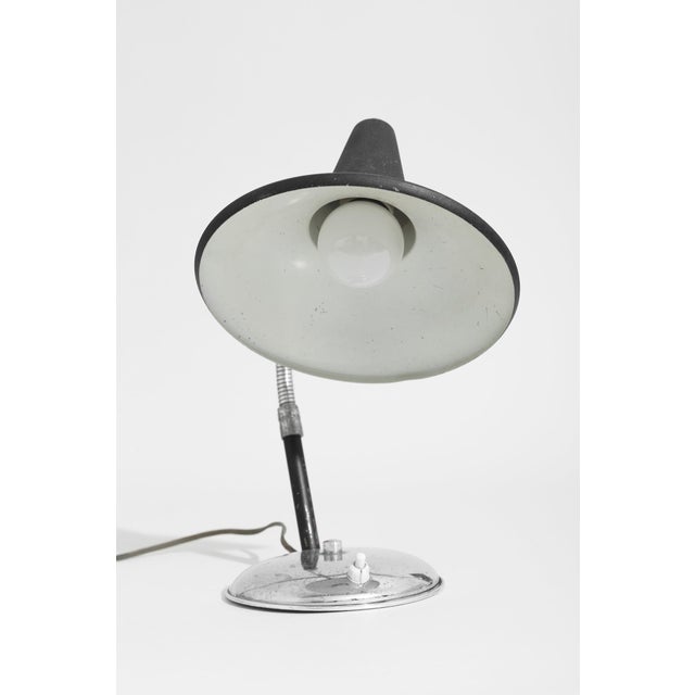 A refined European table lamp. Lamp uses standard bulb and rewired for U.S. use. Lamp is in working condition. Material...
