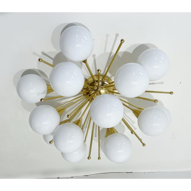 Italian sputnik flush mount with glossy white Murano glass globes mounted on solid brass frame in lacquered polished brass...