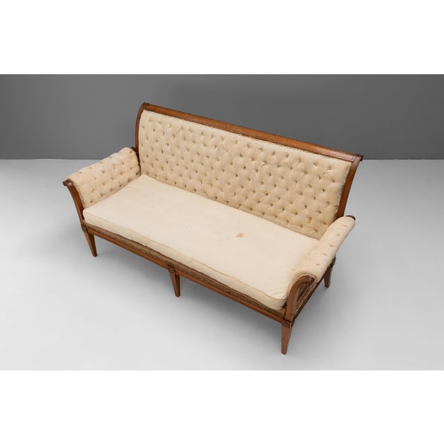 Deconstructed French settee on tapered legs in cherrywood. Circa 1920