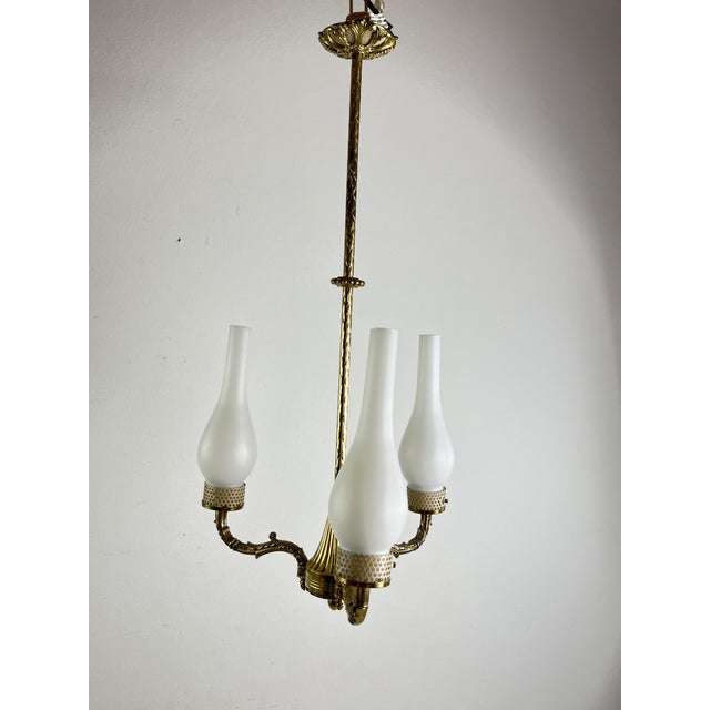 Mid-Century 3-light chandelier in brass and opaline glass in the 1950s Stilnovo style Intact and in good condition, small...