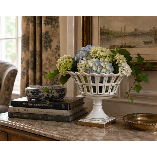 A refined reticulated porcelain basket, executed in a neoclassical idiom with delicate openwork and restrained gilt...