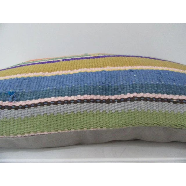 This is a pillow cover made from a vintage kilim rug. The piece was properly washed and ready to use. Pillow inserts not...