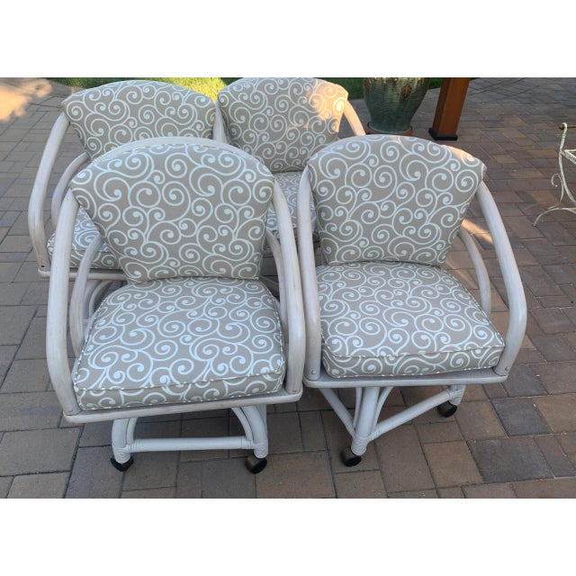 Vintage chippendale style Ficks Reed Rattan dining set including four swivel chairs and 42" glass round table. Cushions...