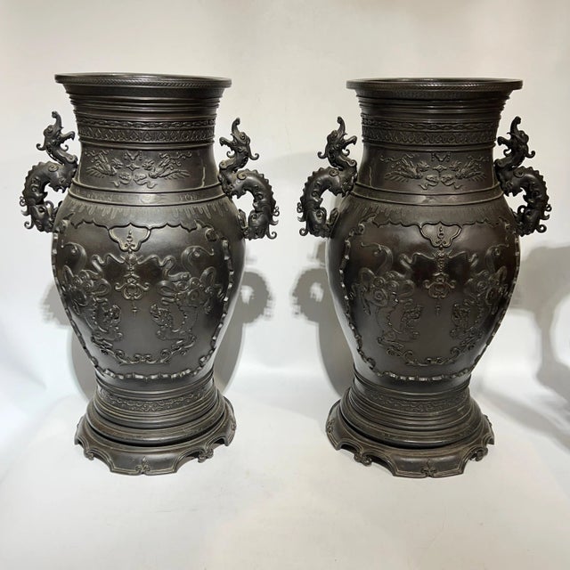 Pair of very fine Meiji period Japanese bronze vases with dark brown patina with dragon handles and exceptional designs of...