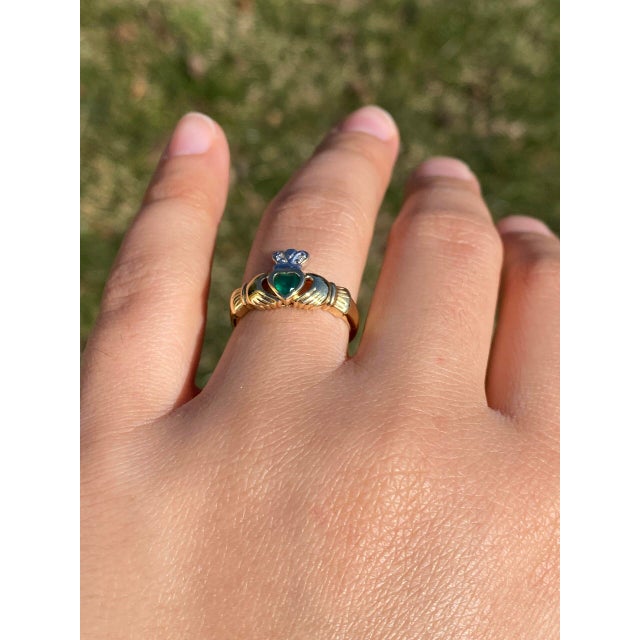 The Clad: Irish Made Claddaugh Ring in Yellow Gold with Chalcedony and Diamond. This distinctive ring features a central...