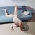 Untitled II by Ale Casanova | Oil on canvas depicting a figure in a contorted pose on a couch. For Sale