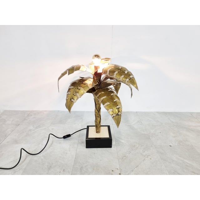 Beautiful torch cut brass palm tree table lamp by Maison Jansen. This palm lamp has a top mounted light point. Base is...