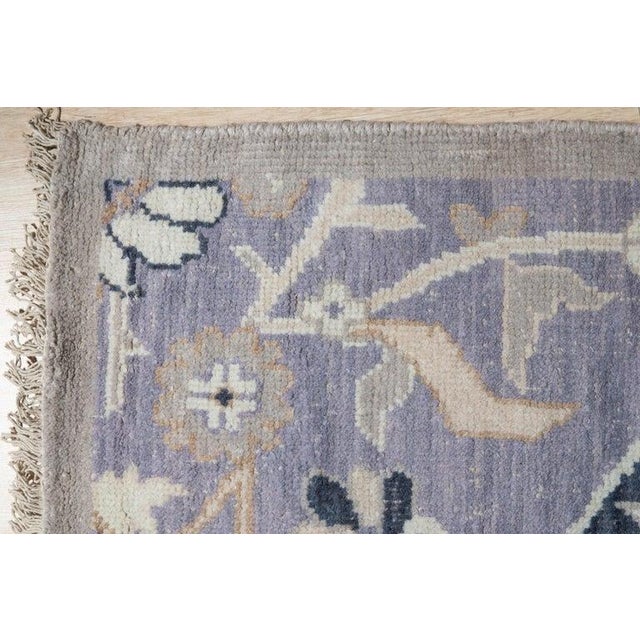 This hand knotted pile rug features a primary gray color palette and is crafted from natural wool. Designed in the classic...