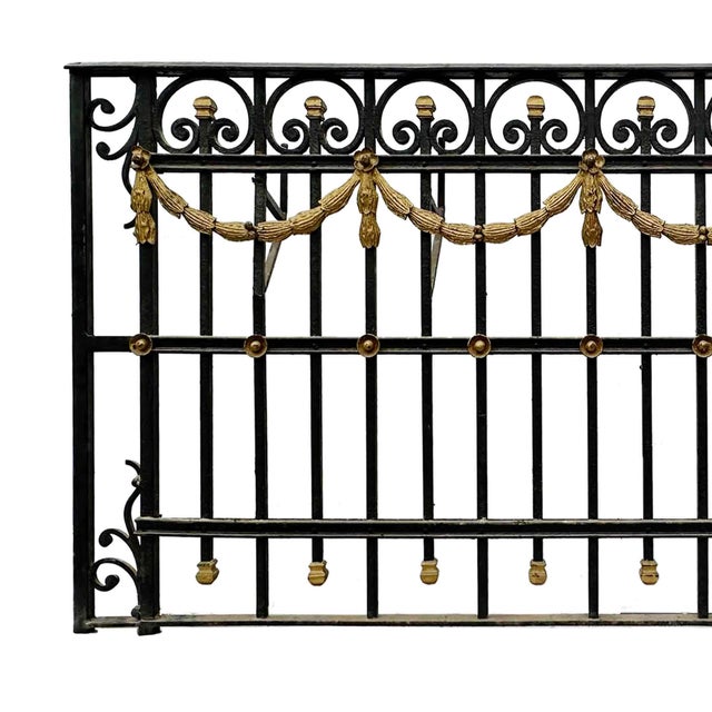Antique wrought iron balcony railing featuring intricate decorative elements featuring with hand forged ornamentation. It...