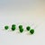 A set of 7 vintage blown art glass drink stirrers. Each made with a green and red olive on top. Each measures 4.75"L x .5"...