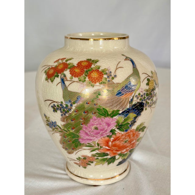 Gracefully hand-painted with vibrant peacocks nestled among blooming peonies, chrysanthemums, and bamboo, this vintage...