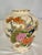 Gracefully hand-painted with vibrant peacocks nestled among blooming peonies, chrysanthemums, and bamboo, this vintage...